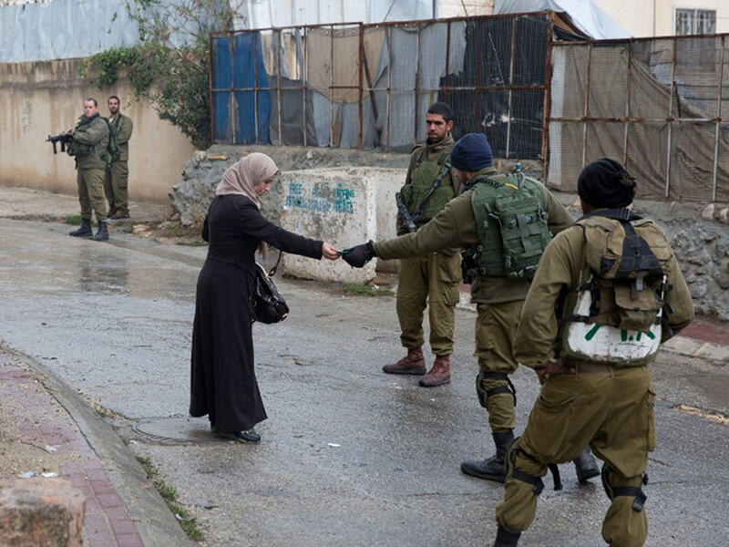 israeli soldiers check woman's ID