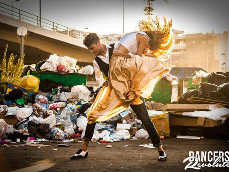 beirut dancers in front of trash heaps