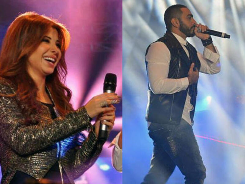Nancy Ajram and Tamer Hosny lovin' on their Cairo crowd.