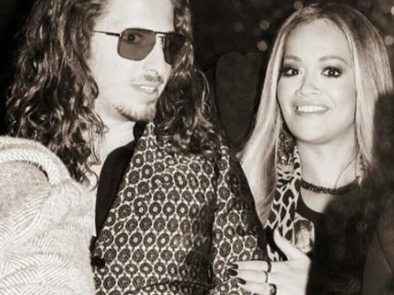 Earlier this week, Rita uploaded a black-and-white snapshot of herself posing with a hand affectionate on the rocker's arm at Monday night's glitzy event London. (Source: Instagram - @ritaora)