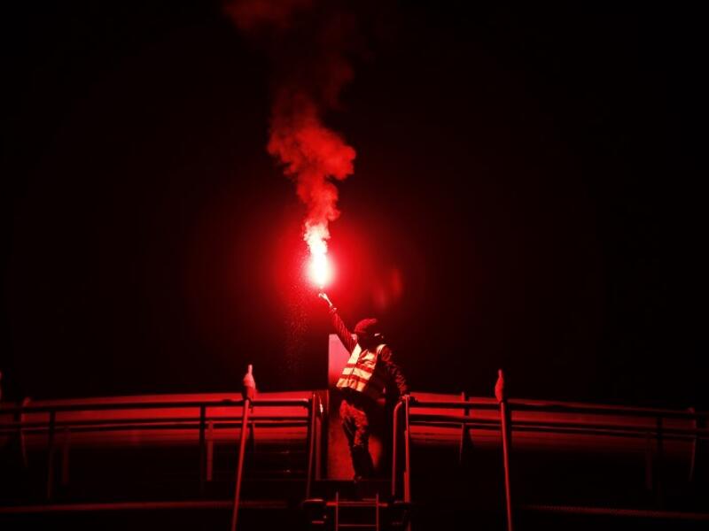 A protester holds a burning flare during a blocking of the ring road of Caen, northwestern France, on November 18, 2018 in Caen.
CHARLY TRIBALLEAU / AFP