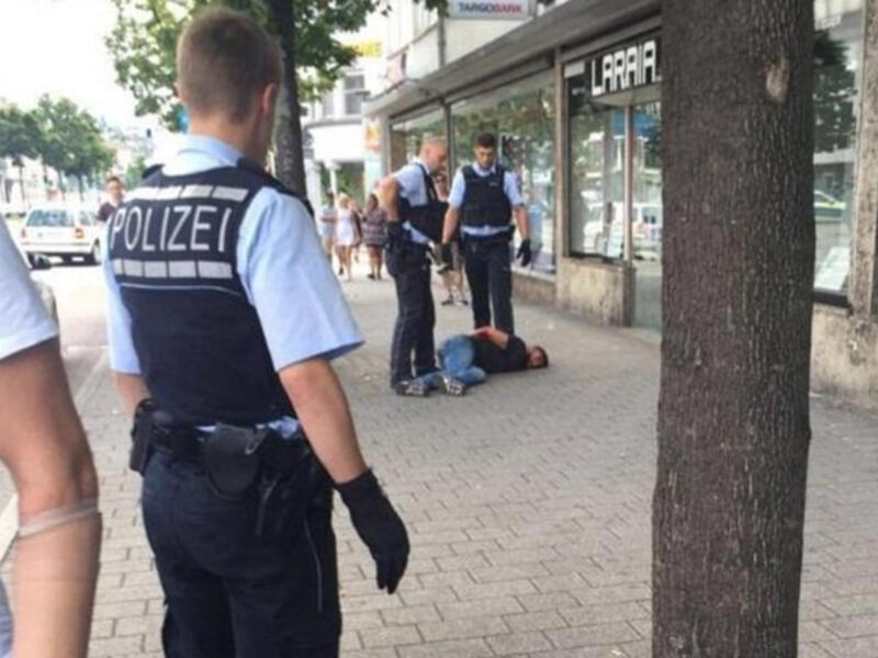 Police are seen arresting the man who began attacking people with a machete during a previous incident in July in the small town of Reutlingen in southwest Germany. (Twitter)