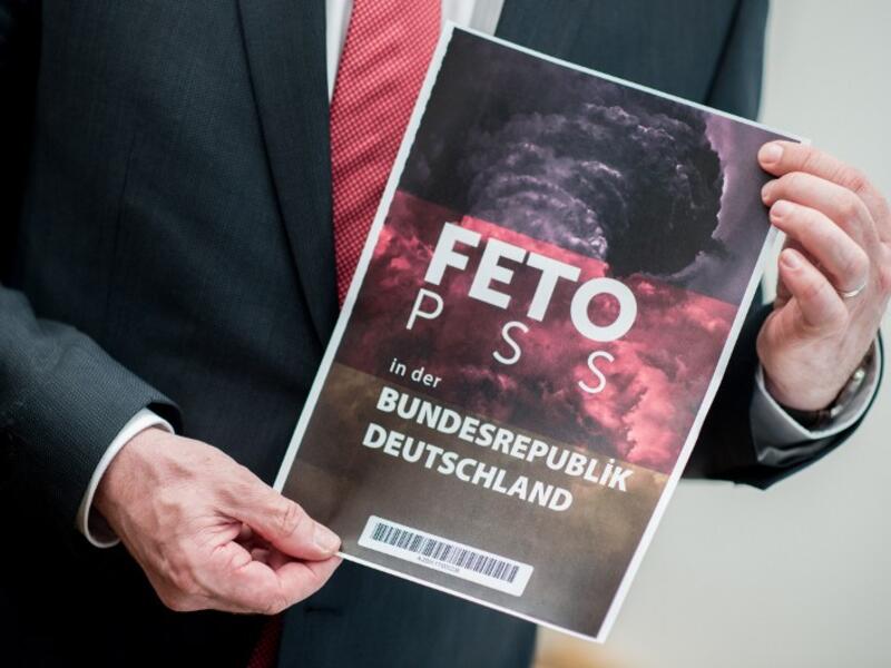 Lower Saxony's Interior Minister Boris Pistorius holds the cover of a list with the names of alleged supporters of the Gulen movement that was handed over to Germany's Federal Intelligence Service (BND) by representatives of the Turkish intelligence service on March 28, 2017. (AFP/Hauke-Christian Dittrich)