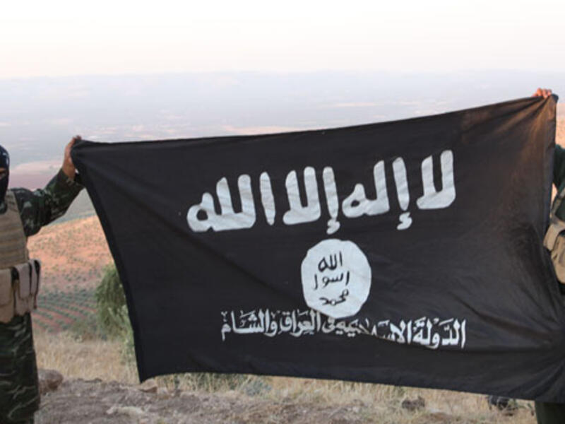 Members of the Daesh militant group in Afghanistan hold up their flag during a propaganda video. (Twitter)