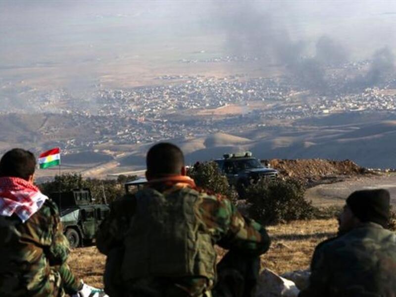 Kurdish peshmerga forces look out over Sinjar, Iraq. (AFP/File)