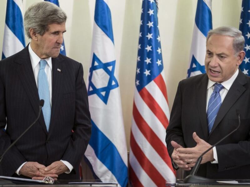 US Secretary of State John Kerry (L) listens as Israeli Prime Minister Benjamin Netanyahu makes a statement to the press before a meeting at the Prime Minister's Office on January 2, 2014 in Jerusalem. [AFP]