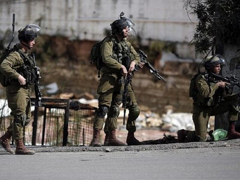 Israeli security forces stand in the street during clashes with Palestinian demonstrators in the West Bank city. (AFP/File)