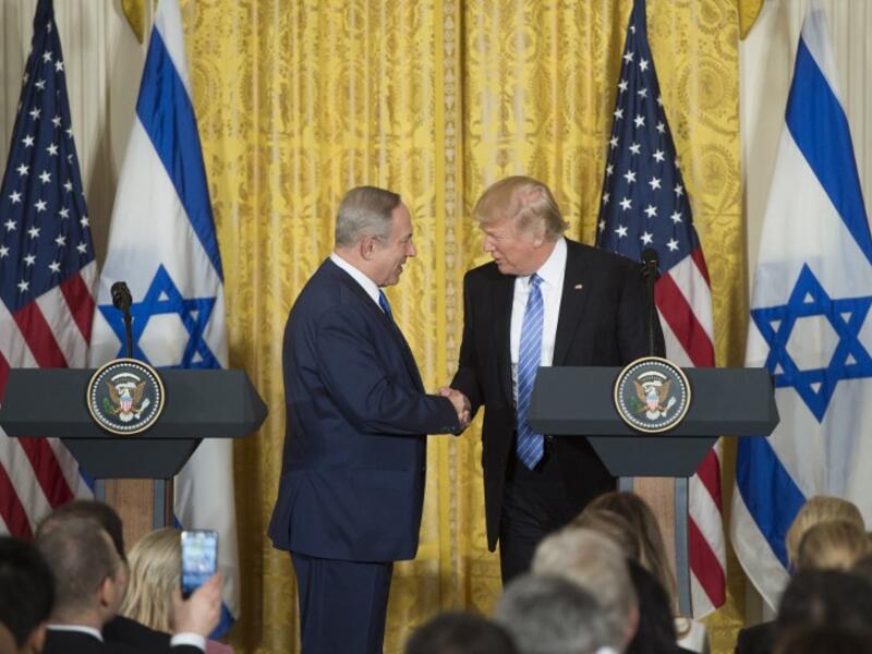 Trump and Netanyahu shake hands at recent press conference [Byline / Source / Credit
Saul Loeb / AFP]