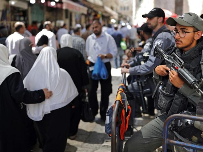 Israeli police stand guard in the main street of the Muslim Quarter in Jerusalem's Old City (AFP/File Photo)