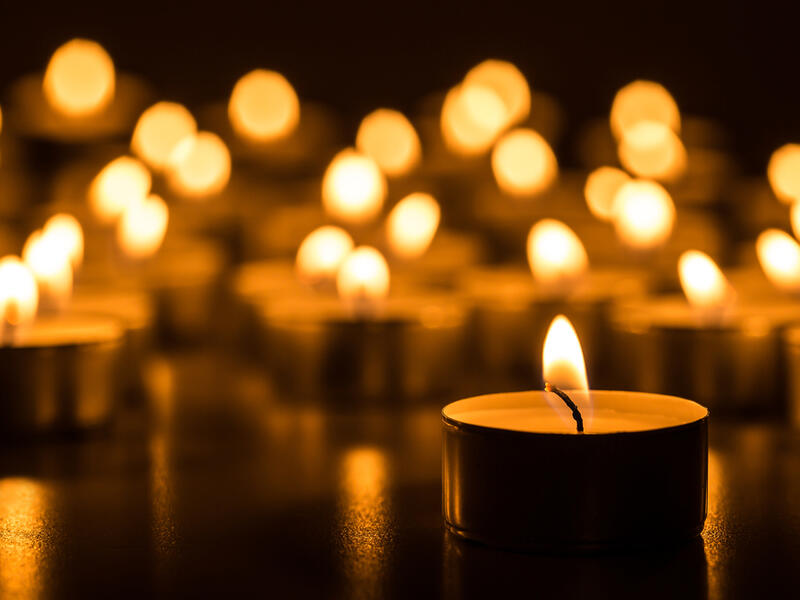 People attend a candle light vigil at the Vilnius Cathedral as it stands unlit during Earth Hour. (AFP/ File Photo)