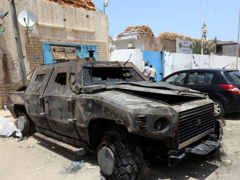 The wreckage of burnt vehicles and ransacked buildings are seen the day after deadly clashes at the Abu Salim police station on June 27, 2013 in Tripoli (Mahmud Turkia / AFP)