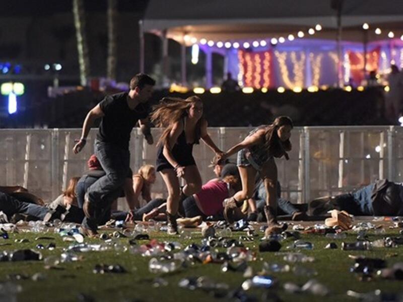 People run from the Route 91 Harvest country music festival after apparent gun fire was heard in Las Vegas (AFP)