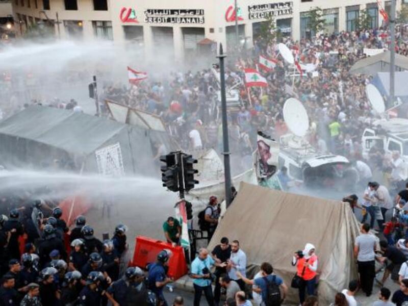 After a trash crisis in July, protesters and a hashtag in Beirut say the streets aren't the only thing that need cleaning. (AFP/File) 