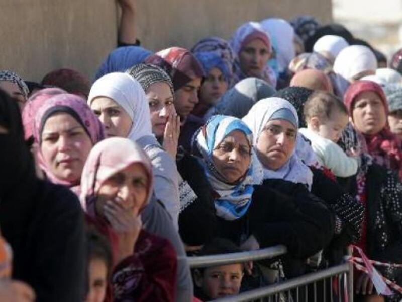 Syrian women wait in Arsal, Lebanon. (AFP/File)