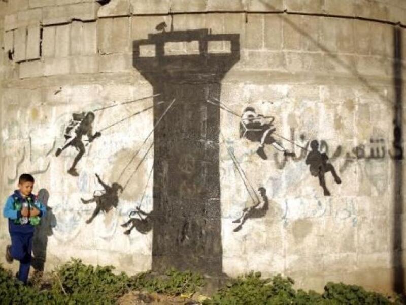 This graffiti is a carousel of children, in Banksy's typical stencil technique /AFP