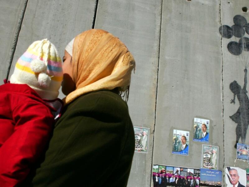 Flying Balloons Girl by Banksy, drawn on the security barrier in Bethlehem /AFP