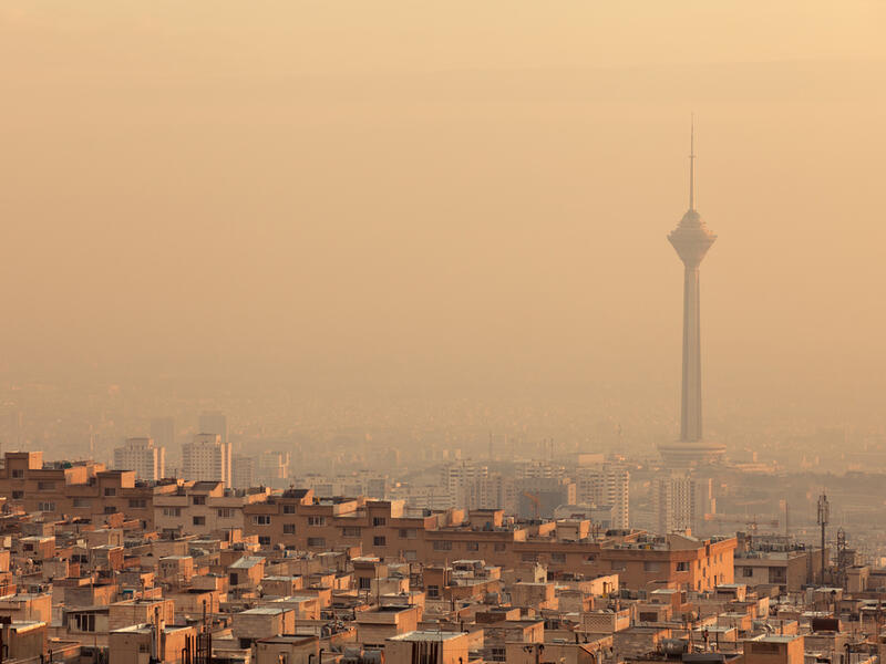 Residential buildings in front of Milad Tower in air-polluted skyline of Tehran illuminated with golden sunset, 435 meters (Shutterstock/File Photo)