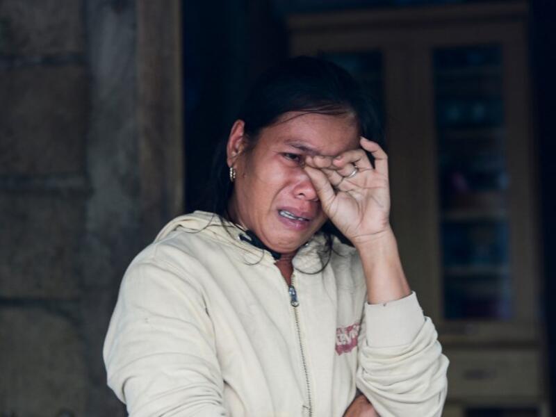A woman weeps as she talks about her family's experience at the height of Super Typhoon Mangkhut in the town of Baggao, Cagayan province on September 15, 2018.TED ALJIBE / AFP