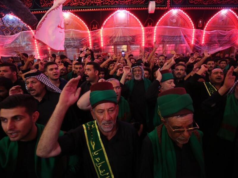 Shiite pilgrims take part in a ceremony at the Imam Hussein shrine in the southern Iraqi city of Karbala on September 19, 2018.AHMAD AL-RUBAYE / AFP