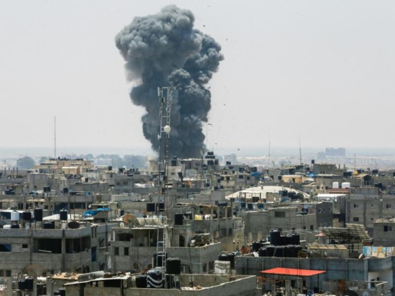 A heavy smoke cloud rises following an Israeli air strike in the southern Gaza Strip city of Rafah on July 14. (AFP)