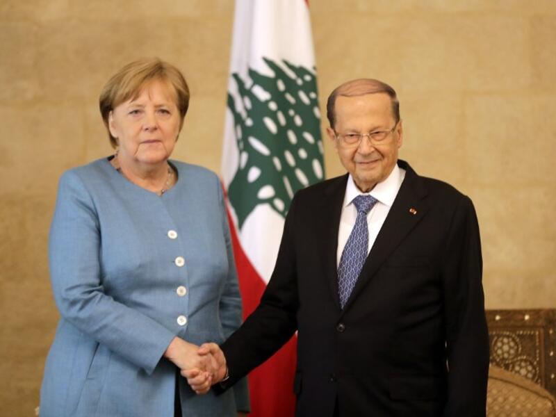 German Chancellor Angela Merkel (L) shakes hands with Lebanese President Michel Aoun at the presidential palace in Baabda, east Beirut, during her official visit on June 22, 2018. (AFP/Joseph Eid)
