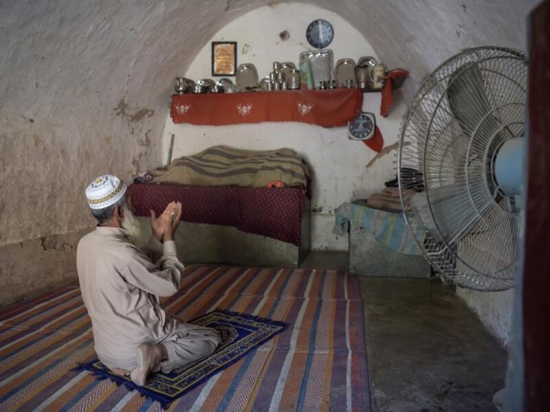 Pakistani villager Faqeer Gul offers noon prayers in his cave room in Nikko village, about 60 kilometres from the capital Islamabad.
AAMIR QURESHI / AFP