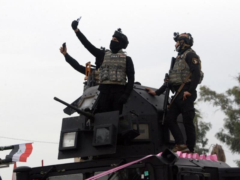 Members of the Iraqi security forces take part in celebrations marking the first anniversary of the country's victory over the Islamic State (IS) group.
Zaid AL-OBEIDI / AFP