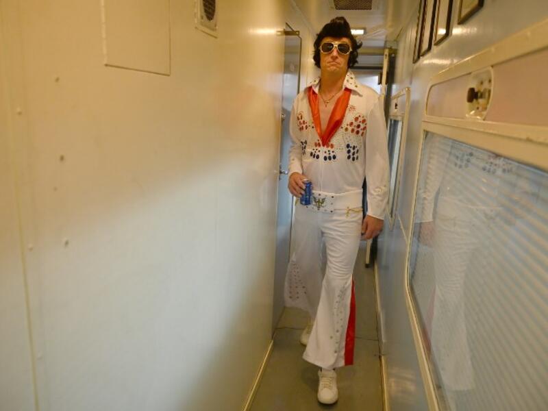 An Elvis fan walks through a train after leaving Central station to head to The Parkes Elvis Festival, in Sydney on January 10, 2019.
SAEED KHAN / AFP