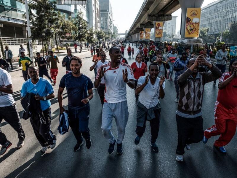 People take part in an exercise on a street in Addis Ababa on February 3, 2019 during the third Car Free Day promoted by local NGOs and the Ethiopian Government to appeal to a healthy life style and a less air pollution of the capital city. 
EDUARDO SOTERAS / AFP