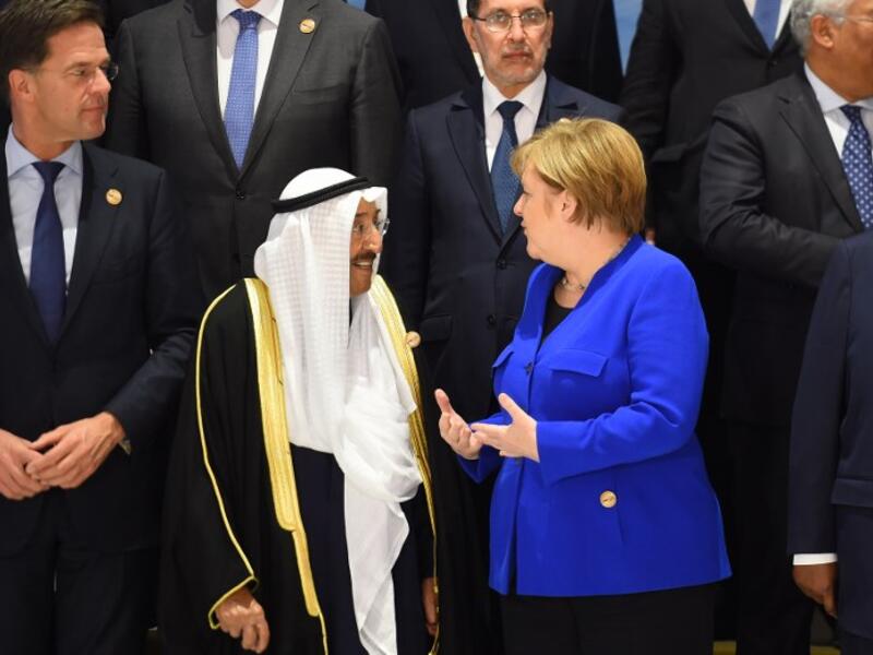 German Chancellor Angela Merkel (blue jacket) talks with Emir of Kuwait Sheikh Sabah al-Ahmad Al-Sabah (L) during the first joint European Union and Arab League summit at the International Congress Centre in the Egyptian Red Sea resort of Sharm el-Sheikh, on February 24, 2019. 
MOHAMED EL-SHAHED / AFP