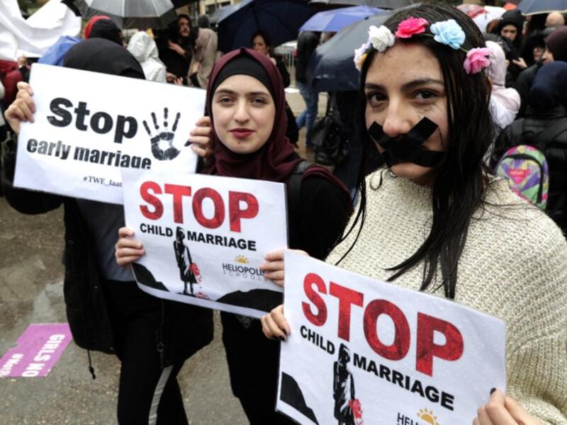 Lebanese women hold placards as they participate in a march against marriage before the age of 18, in the capital Beirut on March 2, 2019. 
ANWAR AMRO / AFP