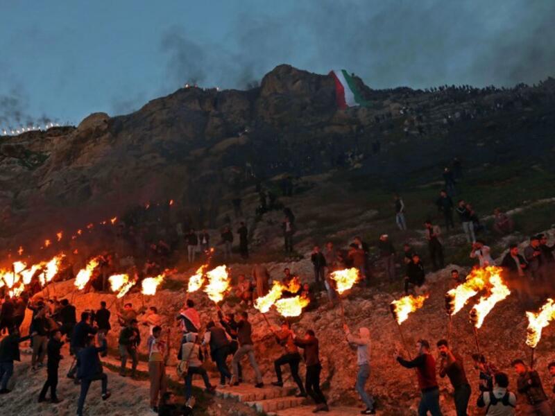 Iraqi Kurds holding lit torches walk up a mountain in the town of Akra, 500 kilometres north of Baghdad, on March 20, 2019 during celebrations of Nowruz (Noruz), the Persian New Year.
SAFIN HAMED / AFP