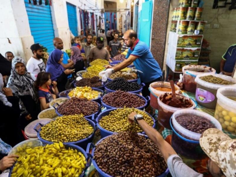 Libyans shop for olives and pickles at a market in the centre of the capital Tripoli, as the faithful prepared for the start of the Muslim holy month of Ramadan. 
AFP/MAHMUD TURKIA

