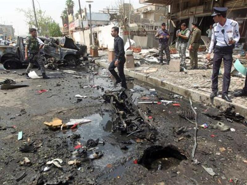 Iraqi security forces inspect the scene of a car bomb blast in the Iraqi capital, Baghdad, on May 9, 2015. (AFP/File) 