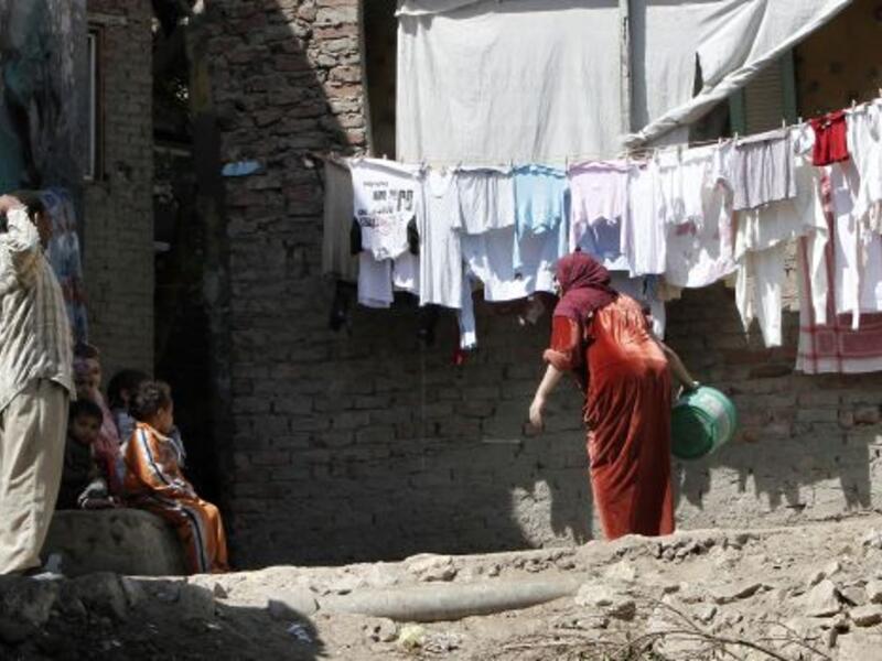 Members of an Egyptian family gather outside their house in a Cairo slum. (AFP/File)