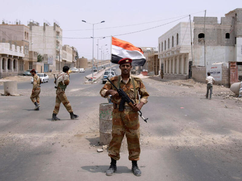 A Yemeni army officer looks on while standing at a checkpoint in Sanaa, Yemen. (AFP/File)