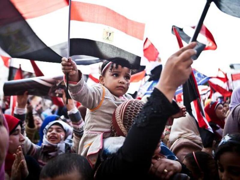 Egyptians wave the national flag in Cairo's Tahrir Square during a rally marking the anniversary of the 2011 Arab Spring uprising on January 25, 2014. (AFP/Virginie Nguyen Hoang) 