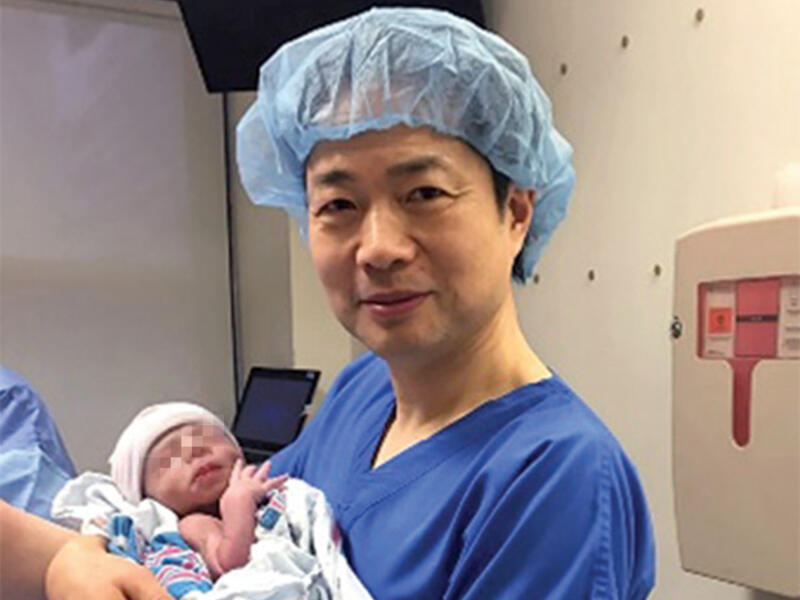 Doctor John Zhang holds the world's first baby with three genetic parents. (Courtesy photo)