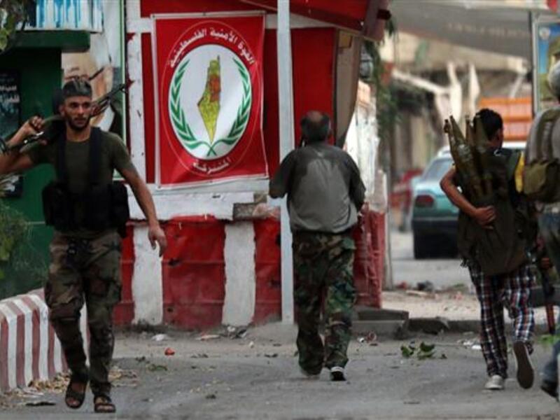 Armed men walk in the streets of Ain al-Hilweh Palestinian refugee camp near Lebanon's southern port city of Sidon following clashes on August 22, 2015. (AFP/File)