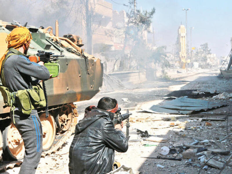 Turkey-backed Syrian opposition fighters take position during their advance in the city of Al-Bab, 30 km from the Syrian city of Aleppo. (AFP/File)