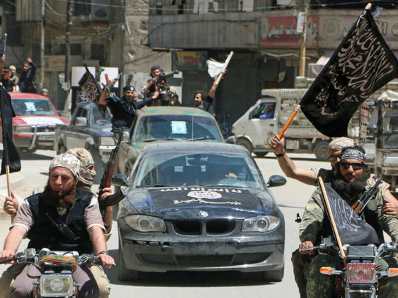 Fighters from Nusra Front-Al Qaeda's affiliate in Syria-parade through Aleppo, May 2015 (AFP)