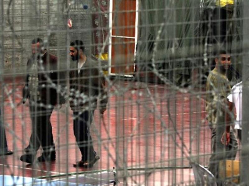 Palestinian prisoners walk at the yard of Megiddo Prison. (AFP/Menahem Kahana) 