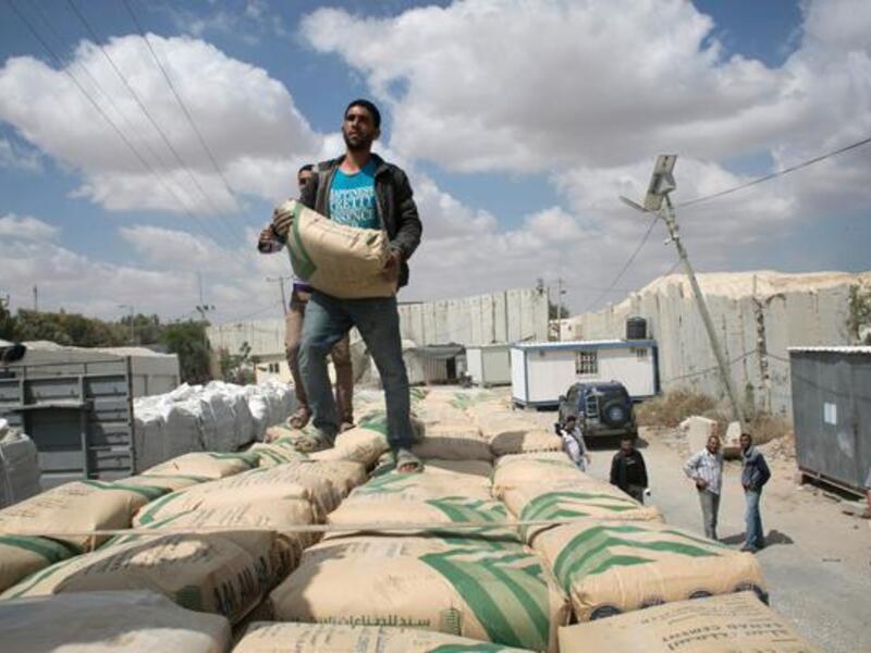 Israel restricts the entry of goods into Gaza out of fears they will be used to build tunnels, but Gazans desperately need cement for reconstruction. (AFP/Said Khatib)