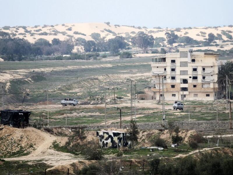 This photo taken on February 9, 2017 shows a picture taken from the southern Gaza Strip of Egyptian soldiers patrolling the Egyptian side of the Rafah border crossing. (AFP/Said Khatib)