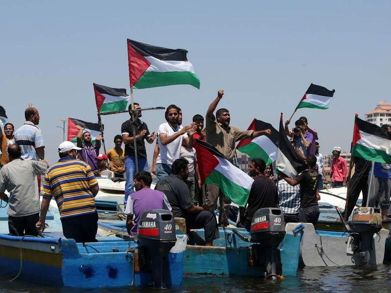 Palestinians rally, Tuesday, in the port of Gaza in support of a flotilla that aimed to break the blockade ( AFP/ File photo)
