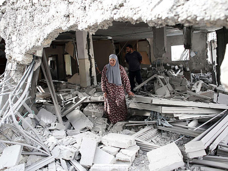 A file photo of a Palestinian woman standing inside her demolished home. (AFP/File)
