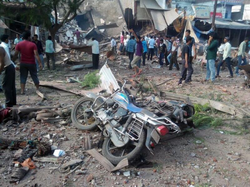 People gather around the site of an explosion at a restaurant in the central Indian state of Madhya Pradesh on September 12, 2015, where 88 people were killed and 100 injured (AFP)