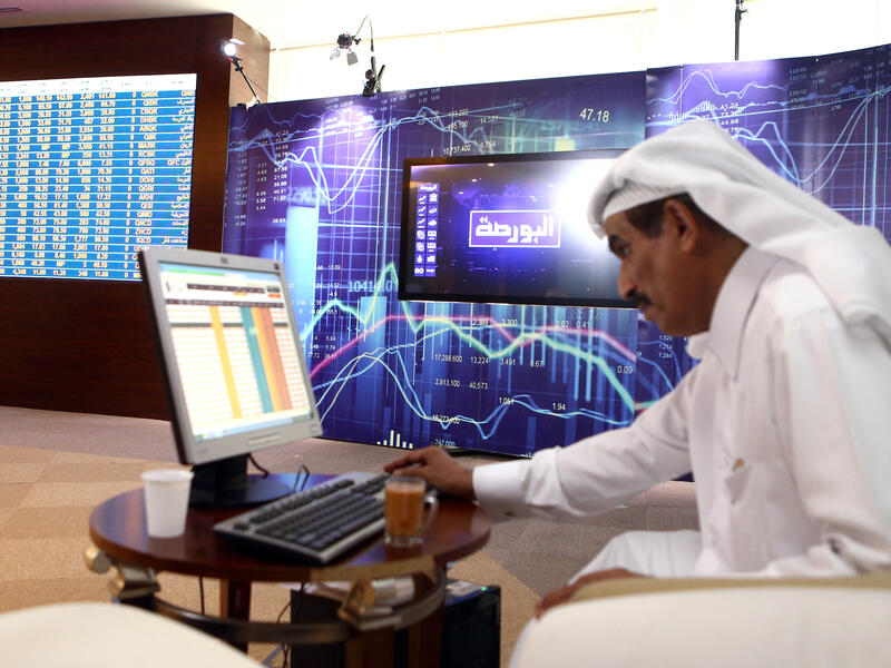A Qatari trader prepares before the opening of the stock market at the Qatari stock exchange in Doha. (AFP) 