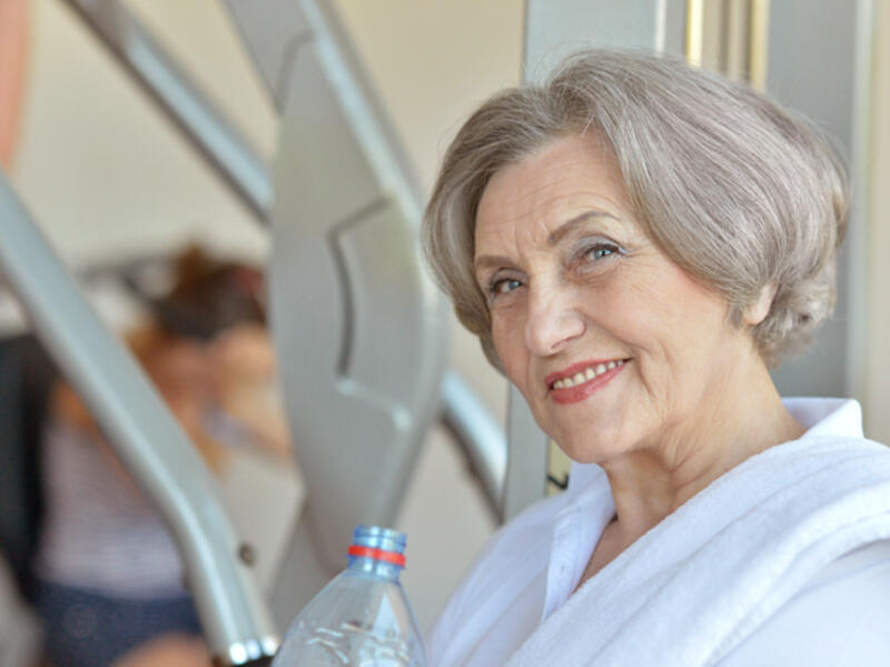 older woman exercising at gym