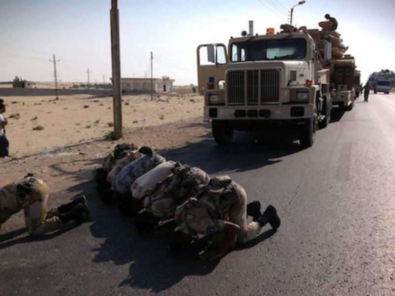 Egyptian soldiers pray as they are deployed in the northern Sinai town of Al-Arish on July 16, 2013. (Source: AFP / STR)